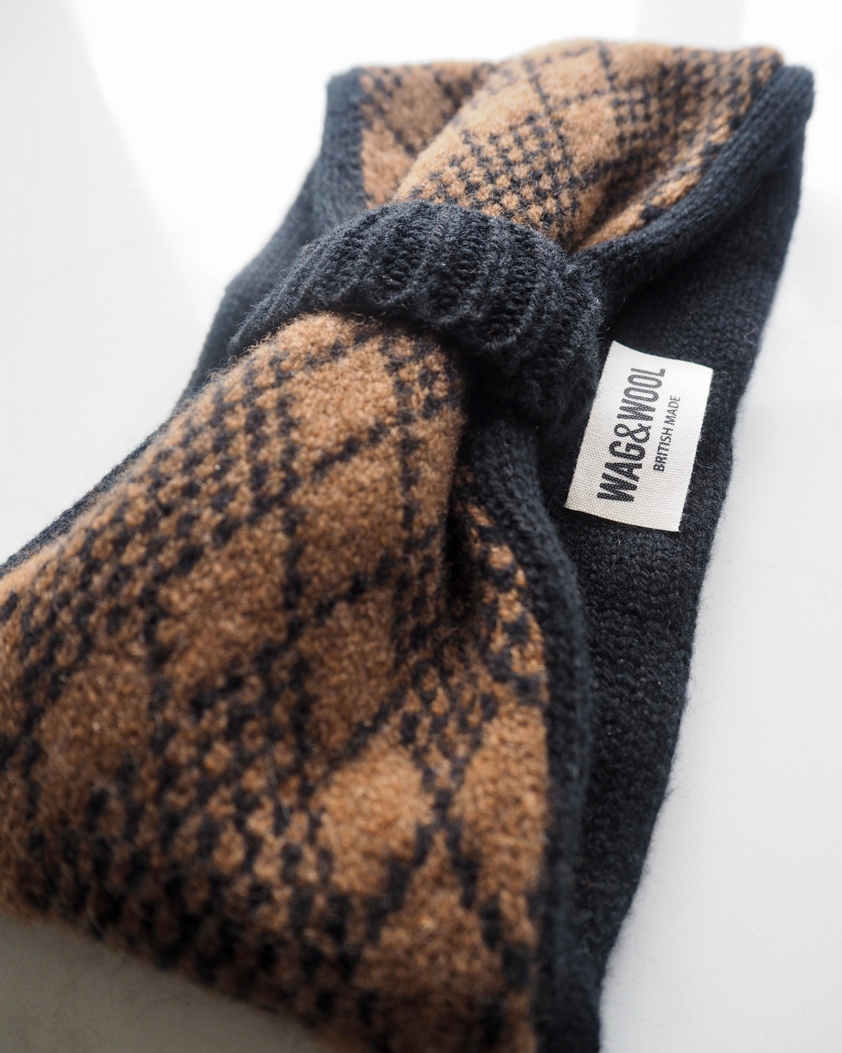 black and brown argyle headband product flat lay