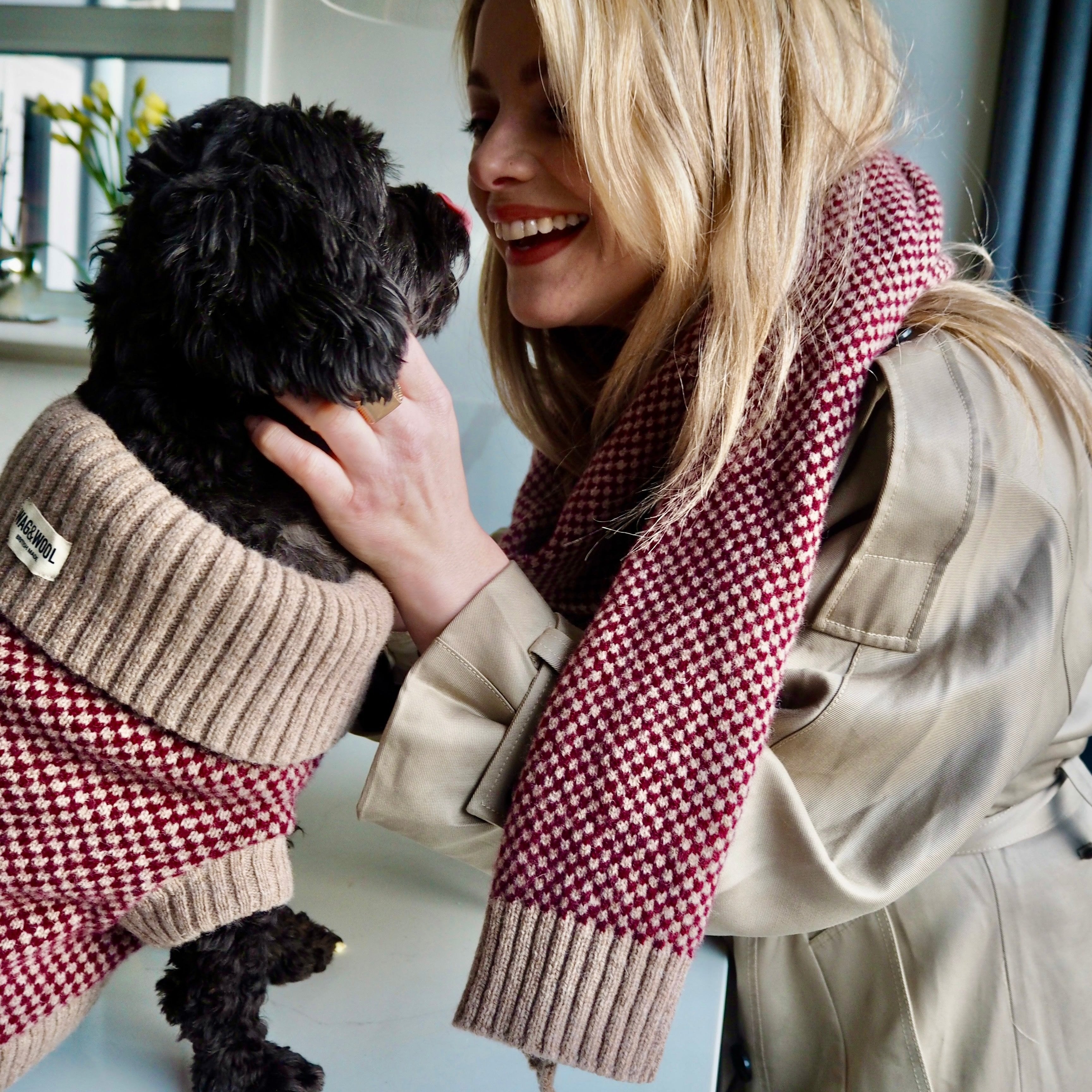 lady and a dog in matching burgundy outfits 