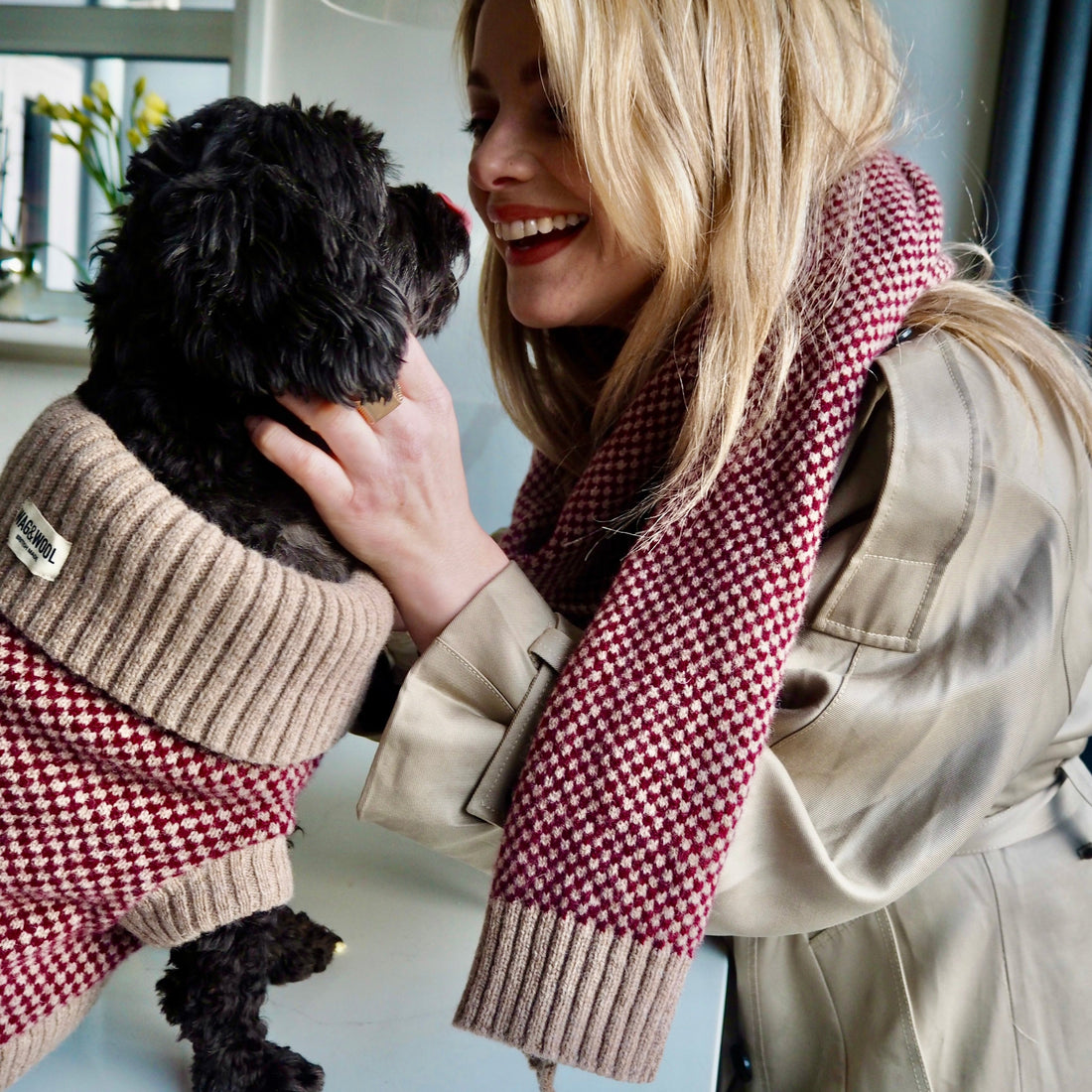 lady and a dog in matching burgundy outfits 